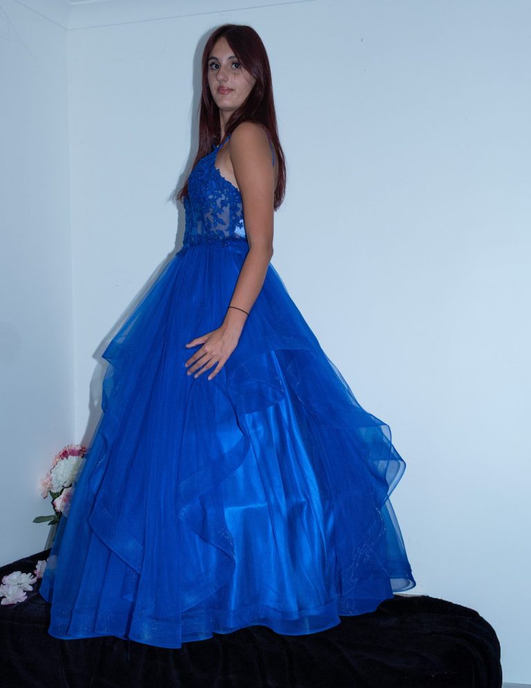 A young woman wearing a long, elegant blue gown.