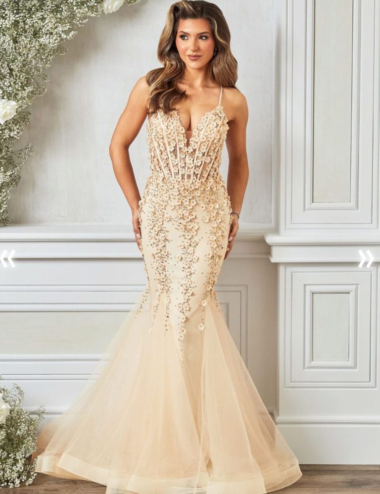 A woman in a fitted, beaded gown with a mermaid silhouette and sheer skirt.